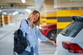 Adult woman using cellphone in underground parking lot Royalty Free Stock Photo