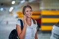 Adult woman using cellphone in underground parking lot Royalty Free Stock Photo