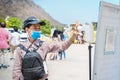 Adult woman using infrared digital thermometer measurement with palm measuring fever at checkpoint for COVID-19 Royalty Free Stock Photo