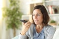 Adult woman using voice recognition on phone at home Royalty Free Stock Photo