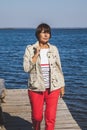 Adult woman walks bridge over sea