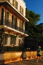 An adult woman walks past Antebellum homes