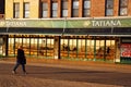 An adult woman walks past a Russian restaurant