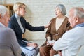 Woman consoling senior patients on meeting