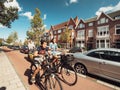 Adult women and young boy people riding bikes on Haarlem street fast commuting