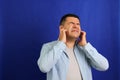 Adult 40-year-old brown Latino man suffers from pain in the ears due to otitis, hypocausia or vertigo Royalty Free Stock Photo