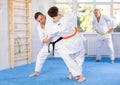 Adult and young men training judo fight Royalty Free Stock Photo