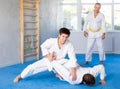 Adult and young men training judo fight Royalty Free Stock Photo