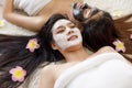 2 adults asian women sleep on white carpet, both of them has long black hair, all smile look happy and face masked black and white Royalty Free Stock Photo