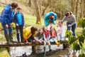 Adults With Children On Bridge At Outdoor Activity Centre Royalty Free Stock Photo