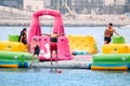 Adults and children with families have fun and run around the AquaFun water park in Dubai