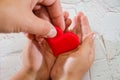 Adults and children hands holding a red heart, healthcare, love, organ donation, family insurance and CSR concept, World Heart Day Royalty Free Stock Photo