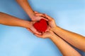 Adults and children hands holding red heart Royalty Free Stock Photo