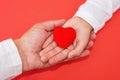 Adults and children hands holding red heart, health care love, give, hope and family concept, world heart day, world health day Royalty Free Stock Photo