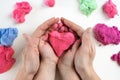 adults and children hands holding a red heart, healthcare, love, organ donation, family insurance and CSR concept, Royalty Free Stock Photo