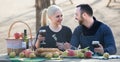 Adults drinking wine at table