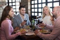 Adults having dinner in restaurant