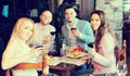 Adults having dinner in restaurant