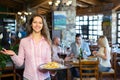 Adults having dinner and waiter