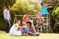 Adults and kids having fun in a garden Royalty Free Stock Photo