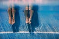 Adults legs underwater in the swimming pool
