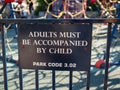 Adults must be accompanied by child park warning sign
