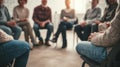 Adults participating in a group therapy session with close chairs arranged in a circle selective focus on their faces Royalty Free Stock Photo