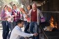 Adults relaxing at grill party Royalty Free Stock Photo