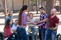 Adults relaxing at grill party Royalty Free Stock Photo