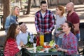 Adults relaxing at grill party Royalty Free Stock Photo