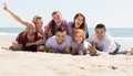 Adults relaxing at sandy beach