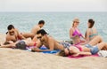 Adults relaxing at sandy beach