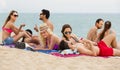 Adults relaxing at sandy beach