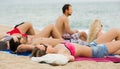 Adults relaxing at sandy beach