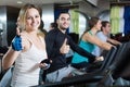 Adults riding stationary bicycles in fitness club Royalty Free Stock Photo