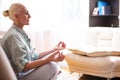 Adults and Seniors Lifestyle Concepts. Tranquil Caucasian Senior Female During Her Yoga Asana Training On Couch Indoors