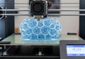 Advanced 3d printer crafting an intricate blue geometric object Royalty Free Stock Photo