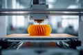 Advanced 3d printer creating an intricate orange geometric object with layered design in a modern industrial workspace with soft Royalty Free Stock Photo