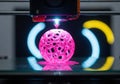 Advanced 3d printer creating an intricate pink sphere Royalty Free Stock Photo