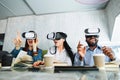 Advanced digital 3d virtual reality technology. Cheerful surprised three multiracial friends sitting in cafe with open Royalty Free Stock Photo