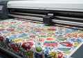 Digital fabric printing machine in action, showcasing vibrant floral patterns on roll-to-roll fabric, illustrating modern textile Royalty Free Stock Photo