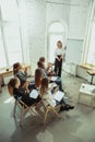 Female caucasian speaker giving presentation in hall at university or business centre workshop Royalty Free Stock Photo