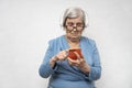 Advanced grandmother listening to the audio in headphones