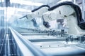 Advanced robotic arms operate on a production line, efficiently assembling components in a high-tech manufacturing facility,