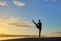Advanced yoga posture in silhouette in a sunset Royalty Free Stock Photo