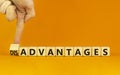 Advantages or disadvantages symbol. Businessman turns a wooden cube, changes the word Disadvantages to Advantages. Beautiful