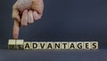 Advantages or disadvantages symbol. Businessman turns wooden cubes, changes the word Disadvantages to Advantages. Beautiful grey