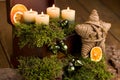 Advent arrangement with candlelight on wood