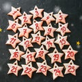 Advent calendar from gingerbread star cookies. Numbers from 1 to Royalty Free Stock Photo