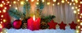 Advent candle and red Christmas decoration . Royalty Free Stock Photo